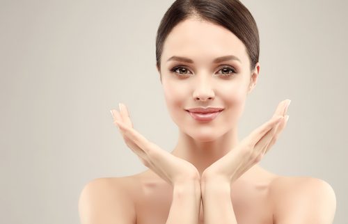 young woman with clean fresh skin holding her hands up-img-blog