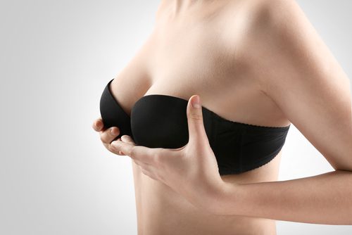 Woman breast in black strapless bra, closeup.Img-blog